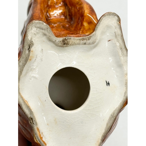 82 - A Late 19th/Early 20th Century pottery squirrel.  13x14cm