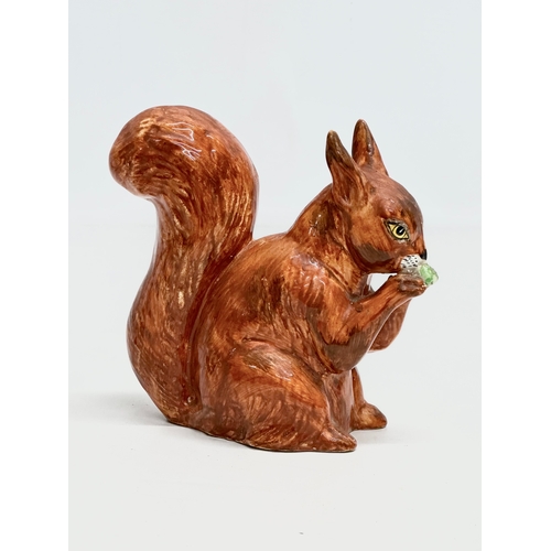 82 - A Late 19th/Early 20th Century pottery squirrel.  13x14cm