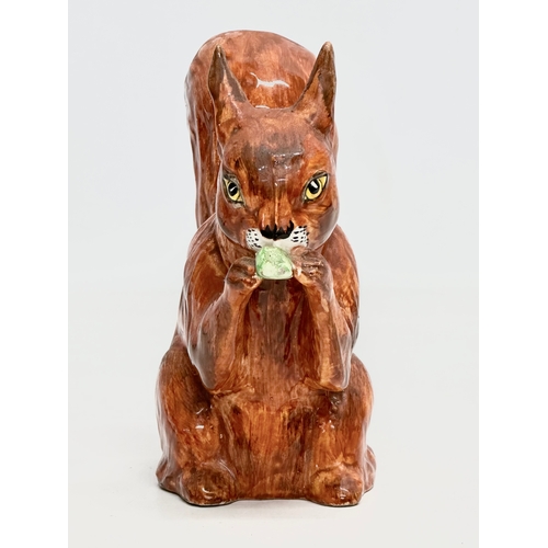 82 - A Late 19th/Early 20th Century pottery squirrel.  13x14cm