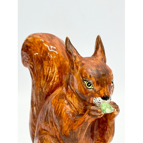 82 - A Late 19th/Early 20th Century pottery squirrel.  13x14cm