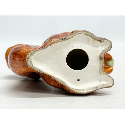 82 - A Late 19th/Early 20th Century pottery squirrel.  13x14cm