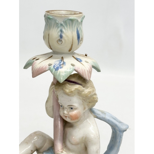 81 - A Late 19th Century German hand painted pottery figural candleholder. 13x7x17cm.