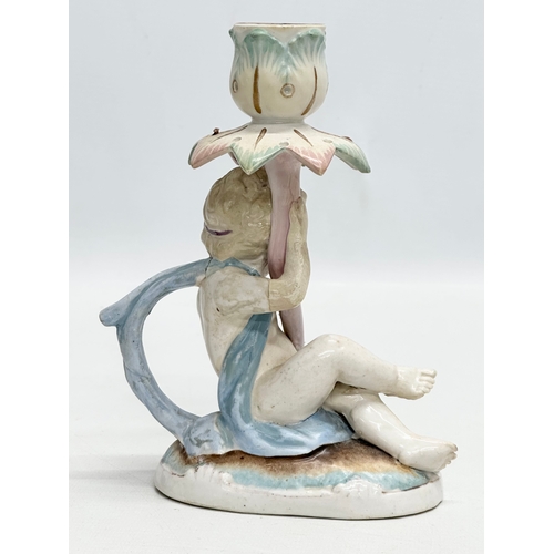 81 - A Late 19th Century German hand painted pottery figural candleholder. 13x7x17cm.