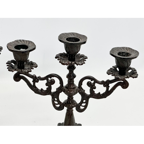 192 - A pair of Late 19th Century Victorian cast iron candelabras. 22x24.5cm.