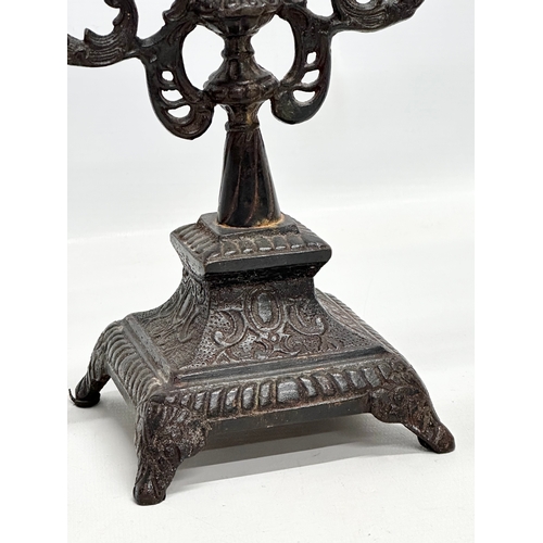 192 - A pair of Late 19th Century Victorian cast iron candelabras. 22x24.5cm.