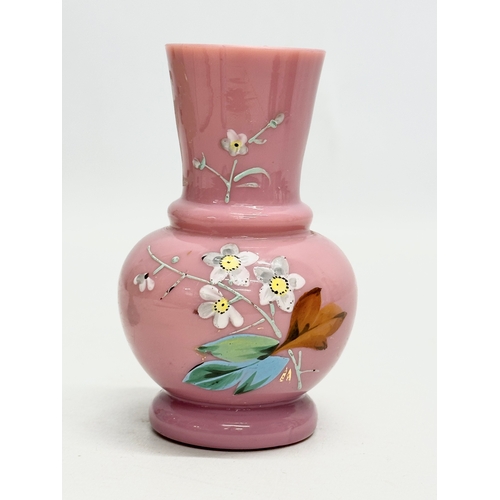 194 - Two Late 19th Century Bohemian opaline glass vases with painted enamel flower motif. 14cm. 12cm.