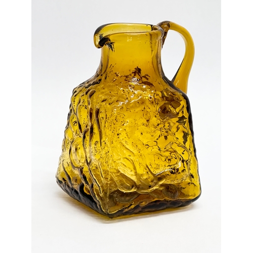 245 - A Mid Century textured amber glass jug. Whitefriars style. 8x7x12cm.