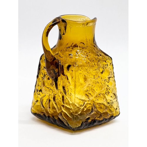 245 - A Mid Century textured amber glass jug. Whitefriars style. 8x7x12cm.