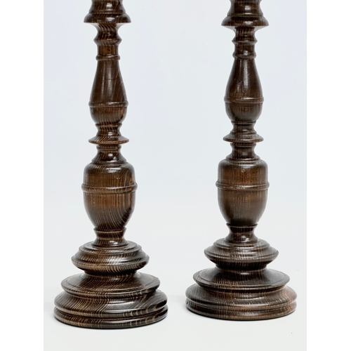 237 - A pair of vintage turned beech candlesticks. 29cm