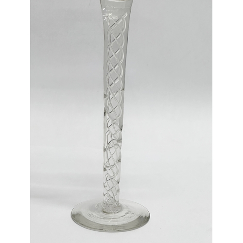 108A - A tall Late 19th Century Victorian twist stem wine glass. In the Georgian style. 22cm.