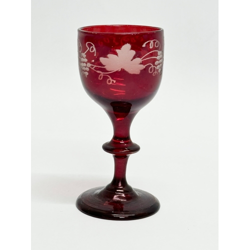 108B - An Early 19th Century Bohemian etched ruby port glass. Circa 1800-1810. 10cm