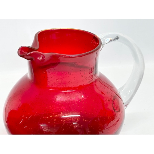 266 - A pair of large Victorian style ruby glass water jugs. 23x20x19cm.