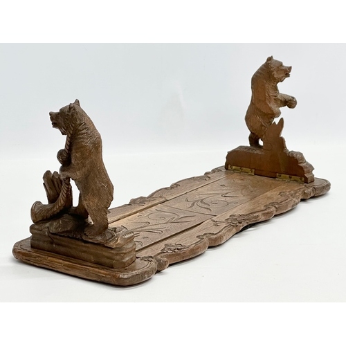 216 - A Black Forest linden wood book stand. Circa 1900. 42x16x18cm