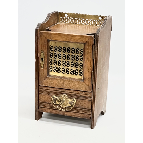 270 - A Late 19th Century Victorian oak smokers cabinet, with brass gallery and mesh door. 15x13x26cm.