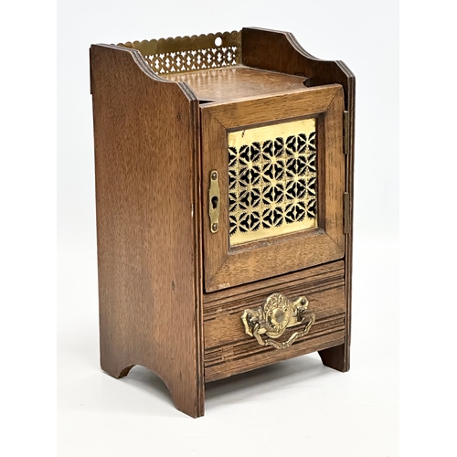 270 - A Late 19th Century Victorian oak smokers cabinet, with brass gallery and mesh door. 15x13x26cm.