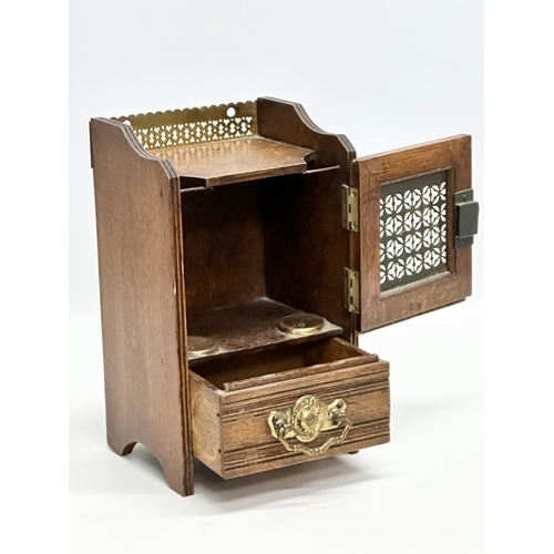 270 - A Late 19th Century Victorian oak smokers cabinet, with brass gallery and mesh door. 15x13x26cm.