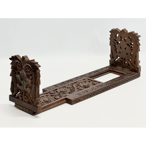 282 - A vintage carved extending bookstand. 33cm