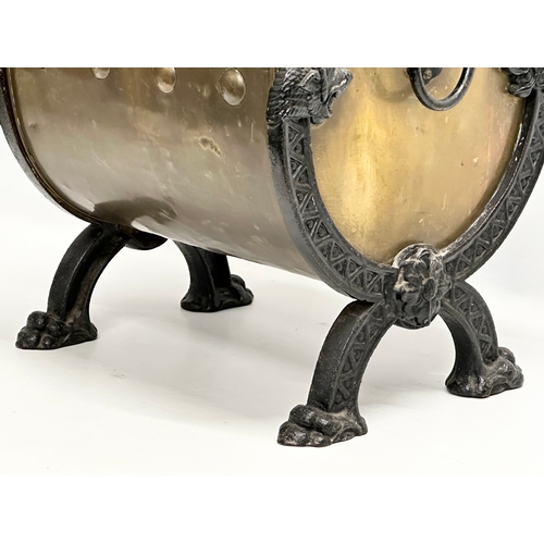 33 - A Late 19th Century Victorian brass coal bucket, with x-framed cast iron lion heads, paw feet and la... 