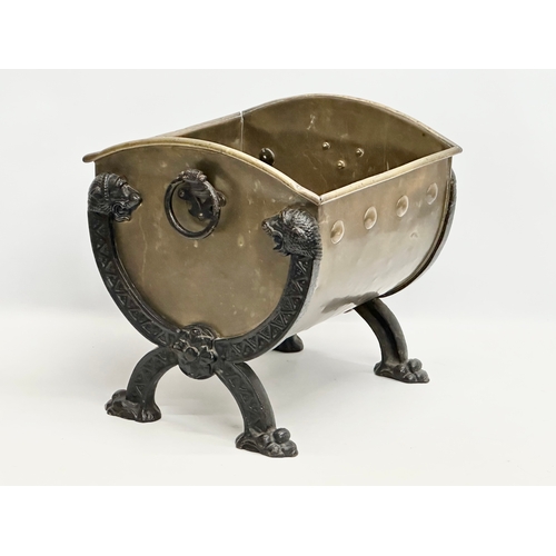 33 - A Late 19th Century Victorian brass coal bucket, with x-framed cast iron lion heads, paw feet and la... 