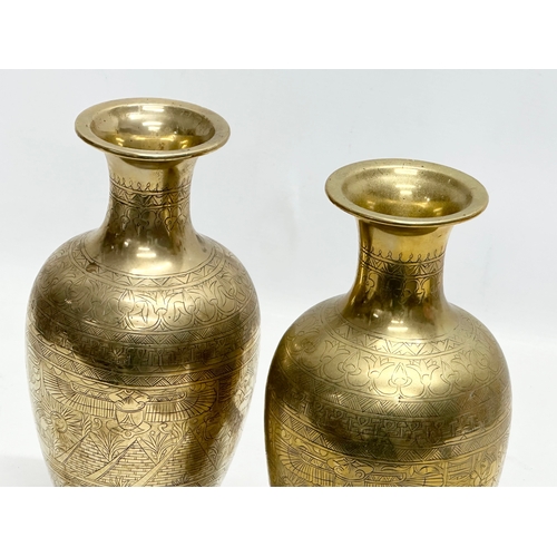 373 - A pair of Late 19th/Early 20th Century Egyptian Revival engraved brass baluster vases. 26cm