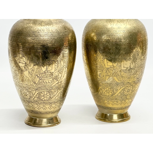 373 - A pair of Late 19th/Early 20th Century Egyptian Revival engraved brass baluster vases. 26cm