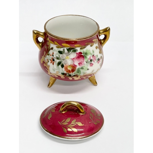 391 - A small French hand painted cauldron form pot. Marked. Serves style. 9x7x10cm