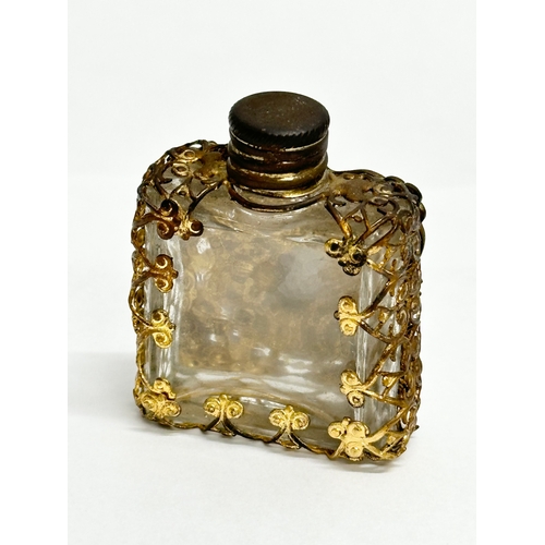 393 - A small Early 20th Century gilt brass mounted perfume bottle with porcelain panel. 4x5cm