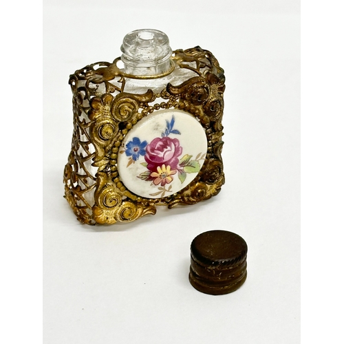 393 - A small Early 20th Century gilt brass mounted perfume bottle with porcelain panel. 4x5cm