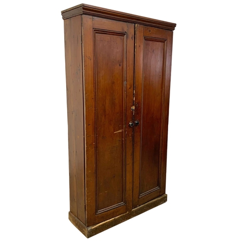 25 - A Victorian pine 2 door cupboard with fitted shelves in original scumble paint. Circa 1870. 110 x 36... 