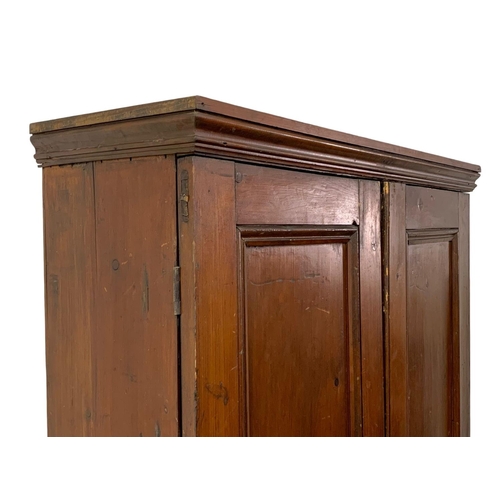 25 - A Victorian pine 2 door cupboard with fitted shelves in original scumble paint. Circa 1870. 110 x 36... 