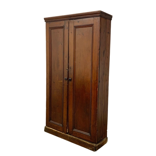 25 - A Victorian pine 2 door cupboard with fitted shelves in original scumble paint. Circa 1870. 110 x 36... 