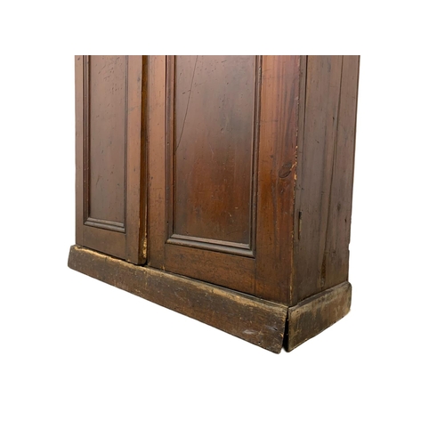 25 - A Victorian pine 2 door cupboard with fitted shelves in original scumble paint. Circa 1870. 110 x 36... 