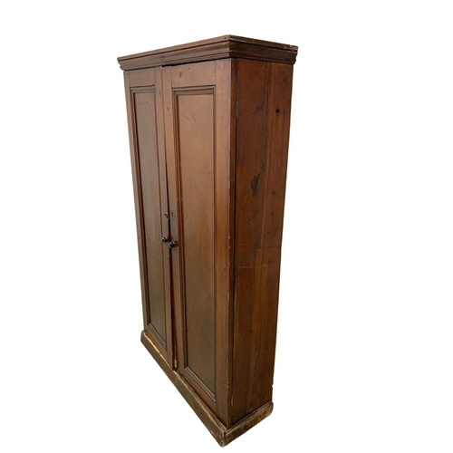 25 - A Victorian pine 2 door cupboard with fitted shelves in original scumble paint. Circa 1870. 110 x 36... 