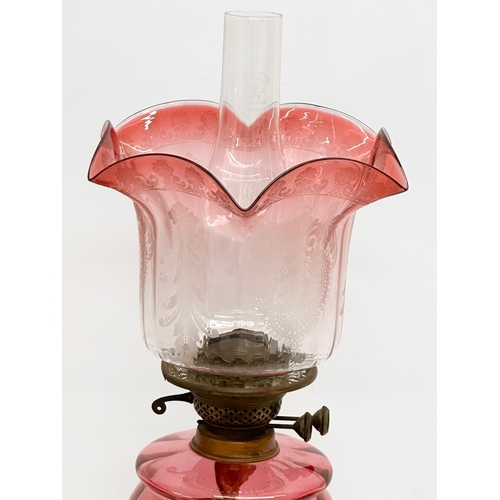 382C - A 19th Century Victorian double burner oil lamp with ruby glass bowl and shade. 68cm