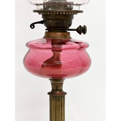 382C - A 19th Century Victorian double burner oil lamp with ruby glass bowl and shade. 68cm