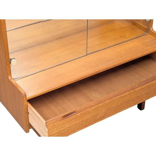 123 - A Mid Century teak display cabinet by Turnidge of London. With drawer and fitted glass shelves. 91.5... 