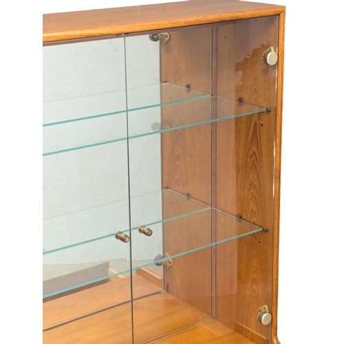 123 - A Mid Century teak display cabinet by Turnidge of London. With drawer and fitted glass shelves. 91.5... 