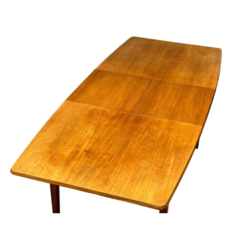 127 - A 1960’s Mid Century teak extending dining table and 4 chairs. Closed 135x80x73cm. Open 182cm. 6