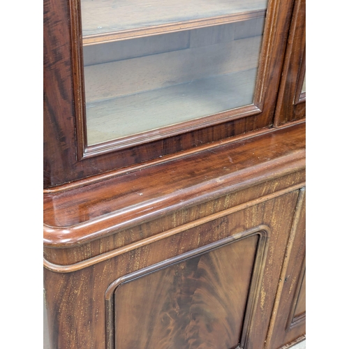 197 - A large 19th Century Victorian mahogany double glazed door bookcase with adjustable shelves. 146x50x... 