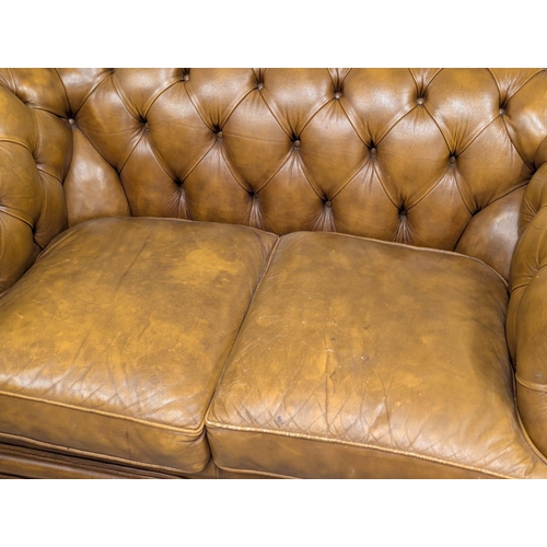 202A - A Victorian style deep button back leather sofa. 150cm. 5