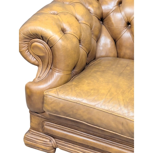 202A - A Victorian style deep button back leather sofa. 150cm. 5