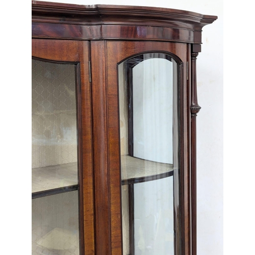 206 - A large Edwardian mahogany display cabinet with astragal glazed and bow front panel door . Circa 190... 