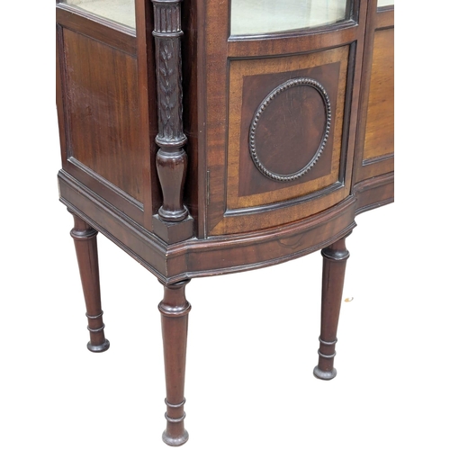 206 - A large Edwardian mahogany display cabinet with astragal glazed and bow front panel door . Circa 190... 