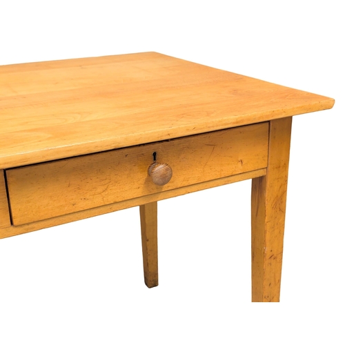 224 - A 1950s beech kitchen table with 2 drawers on square tapering legs. 137x77x76cm. 2