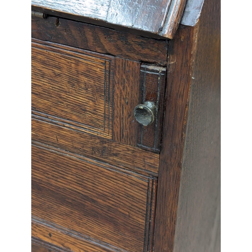 229 - An Early 19th Century George III oak bureau with brass bun handles and bracket feet. Circa 1800. 97x... 