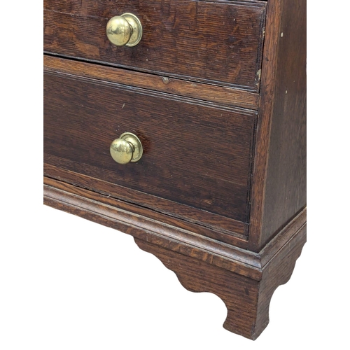 229 - An Early 19th Century George III oak bureau with brass bun handles and bracket feet. Circa 1800. 97x... 