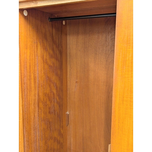 242 - A Mid Century teak wardrobe by Symbol. 122x57x172cm. 1