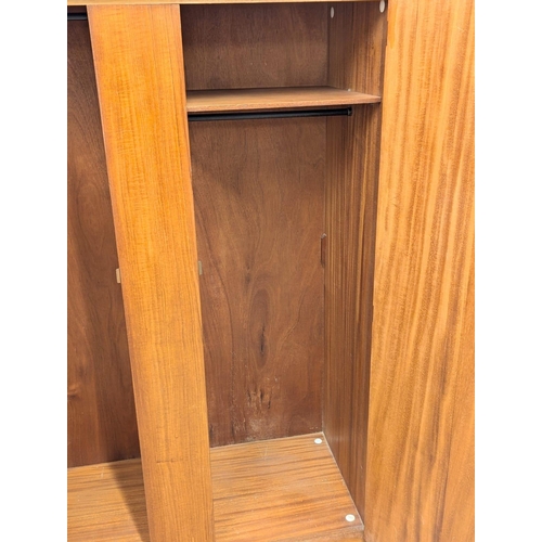 242 - A Mid Century teak wardrobe by Symbol. 122x57x172cm. 1