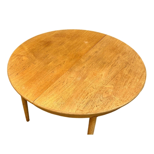 257 - A Mid Century “Cheetham” teak extending dining table. Open 170x122x73cm. Closed 122x73cm. 4