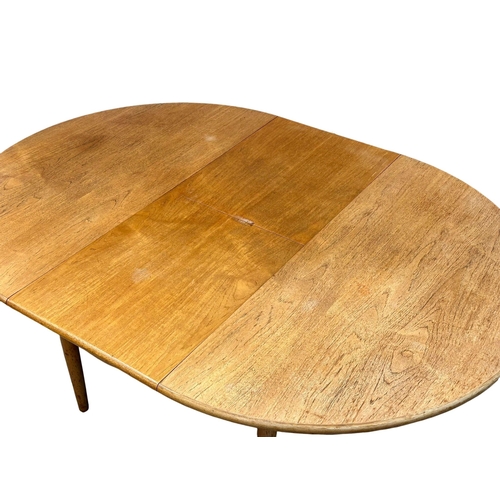 257 - A Mid Century “Cheetham” teak extending dining table. Open 170x122x73cm. Closed 122x73cm. 4